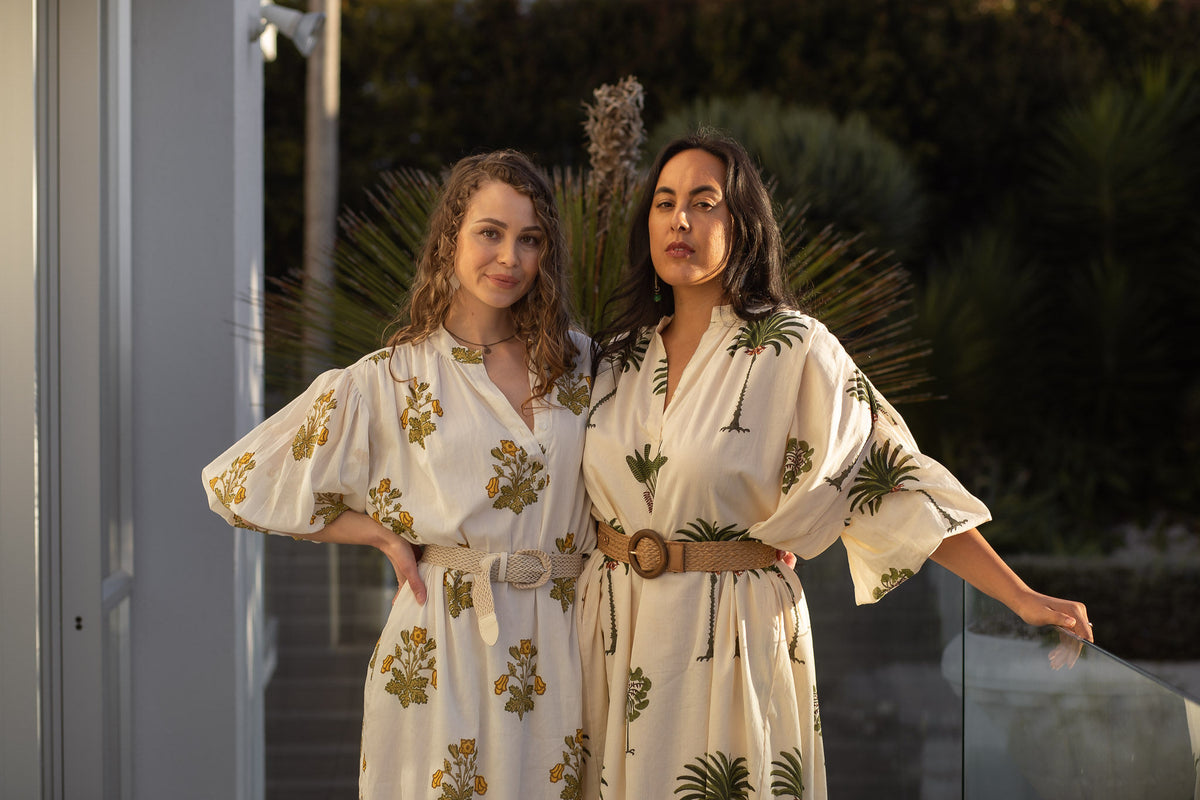 Two girls posing wearing kaftans